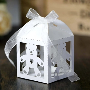 Close-up of white laser-cut teddy bear candy box with a delicate organza ribbon bow