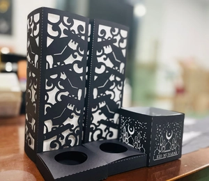 Detail of laser-cut black Eid Mubarak paper candle holders and decorative gift boxes