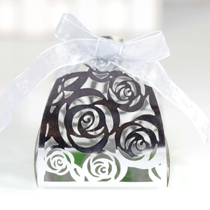 Laser-cut silver hollow rose wedding candy box with a white satin ribbon bow