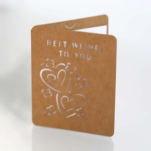 Macro detail of laser-cut Best Wishes text and heart pattern on kraft paper card
