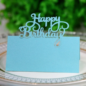 Detailed view of blue glitter laser-cut Happy Birthday place card on ceramic plate