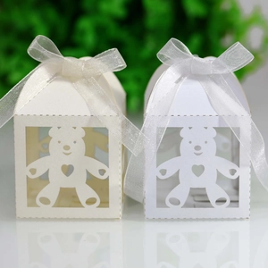 Close-up of hollow bear candy boxes with pearlescent finish and white organza ribbons