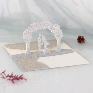 Detailed laser-cut wedding invitation featuring 3D silver glitter rose and couple silhouette
