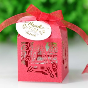 Macro shot of red laser-cut Eiffel Tower gift box with ribbon and thank you tag