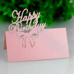 Close-up of pink glitter hollow Happy Birthday place card with bow design