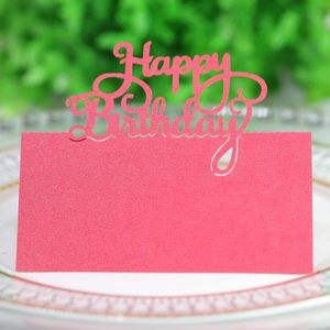 Macro shot of pink Happy Birthday place card with hollowed lettering on elegant plate
