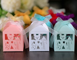 Close-up of hollowed-out bear and baby bottle candy boxes with silk ribbon bows