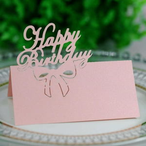 Detail of pink laser-cut Happy Birthday place card with pearl finish and bow design