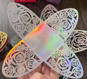Close-up of laser-cut rose hollow candy box with iridescent metallic finish effect