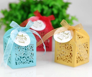 Detailed laser-cut gift boxes with intricate floral patterns and thank you tags