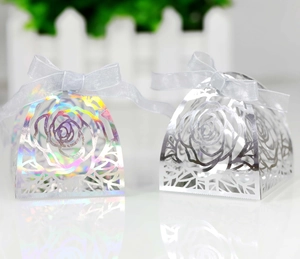 Macro shot of laser-cut rose hollow candy boxes in iridescent and silver finishes