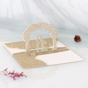 Detail of 3D pop-up wedding card with glitter gold hollow rose arch and couple silhouette