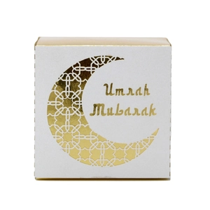 Close-up of Umrah Mubarak white gift box with gold foil moon and intricate lattice pattern