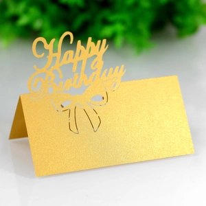 Detailed laser-cut Happy Birthday gold glitter place card with hollow bow design