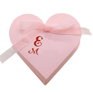 Pink heart-shaped glitter gift box with sheer organza ribbon and elegant bow detail
