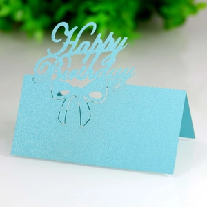 Detailed view of light blue glittery Happy Birthday table card with hollow-out bow design