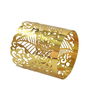 Macro detail of gold laser-cut vine patterns on polished metal napkin ring holder