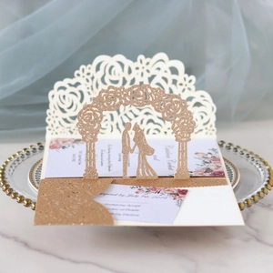 Detail of 3D rose gold glitter wedding invitation with laser-cut arch and couple silhouette