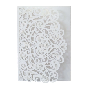 Detailed laser-cut baroque floral patterns on a white wedding invitation cover
