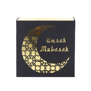 Detail of square black Umrah Mubarak gift box with gold foil moon and hollow pattern
