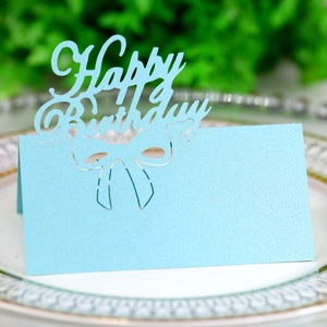Macro shot of light blue laser-cut Happy Birthday place card with pearlescent finish