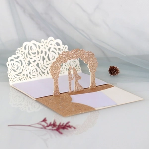 Detail of laser-cut rose wedding card with rose gold glitter and pop-up silhouettes