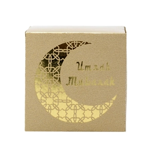 Detail view of square gold Umrah Mubarak candy box with moon laser cut design
