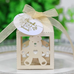 Detailoverzicht van beige beer snoepdoosje met gouden lint en bedankt-label