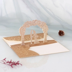 Detail of rose gold laser cut 3D pop-up wedding card with glitter rose arch and couple