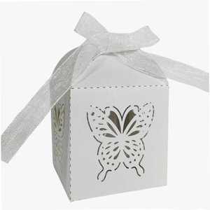 Close-up of white laser-cut butterfly candy box with an organza ribbon bow