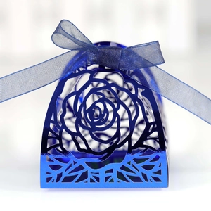 Detailed close-up of dark blue laser-cut rose gift box with elegant matching satin ribbon