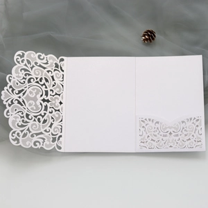 Detailed laser-cut white wedding invitation folder with intricate floral hollow patterns