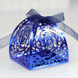 Detail of navy blue laser-cut rose hollow candy box with matching organza ribbon bow