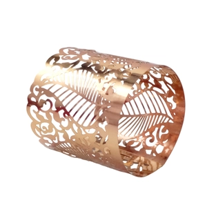 Detailed view of rose gold leaf pattern cutout on a laser-cut metal napkin ring
