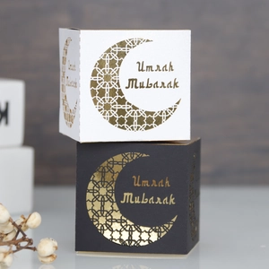Detail showing laser-cut moon pattern and gold Umrah Mubarak text on gift boxes