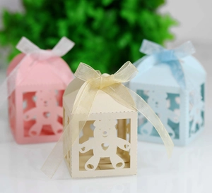 Close-up of laser-cut bear hollow paper gift boxes with elegant ribbon bows