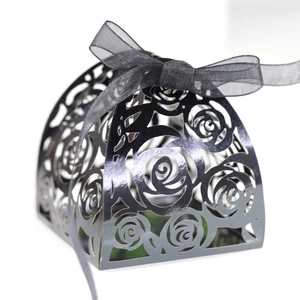 Laser cut black pearl paper favor box with intricate rose patterns and ribbon bow