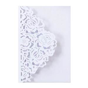 Detailed laser-cut rose patterns on elegant white pearlescent wedding invitation card