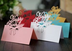 Macro shot of 3D hollow Happy Birthday table cards with pearlescent finish