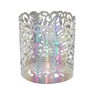 Macro view of laser-cut vine patterns on holographic gold napkin rings for dining decor