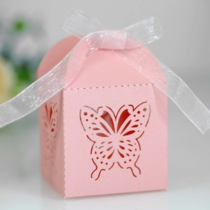 Close-up of pink butterfly laser-cut gift box with glossy texture and white ribbon bow