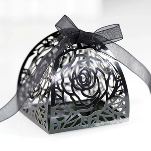Detail of black laser-cut rose hollow favor box with elegant black ribbon bow