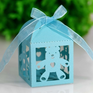 Close-up of laser-cut light blue baby bear gift box with a silk ribbon bow detail