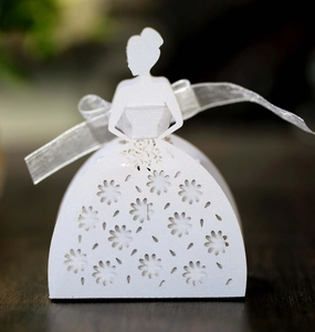 Close-up of laser-cut hollow candy box with elegant bridal silhouette and ribbon