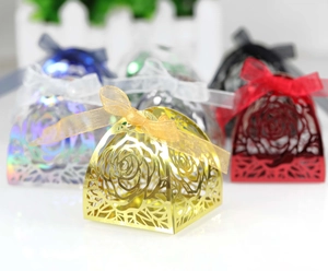 Detailed laser-cut rose pattern on pyramid candy boxes with silk ribbon in multiple colors