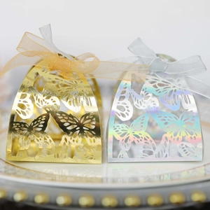 Close-up of laser-cut butterfly gift boxes with iridescent finish and ribbon bows