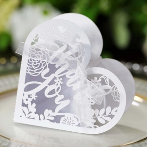 Detail of laser-cut heart favor box with floral patterns and Thank You ribbon