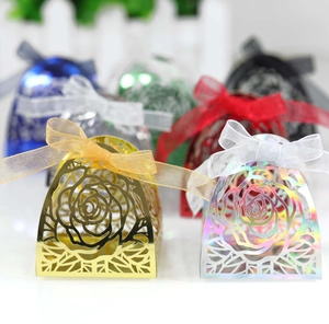 Detailed laser-cut rose hollow favor box with shimmering finish and elegant ribbon