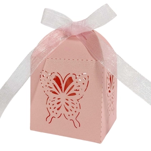 Close-up of pink laser-cut butterfly candy box with a white ribbon bow detail