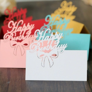 Laser cut hollow Happy Birthday place cards in various colors with bow design